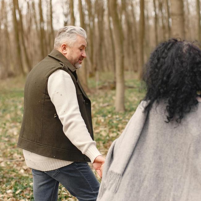 Senior couple walking in the forest.