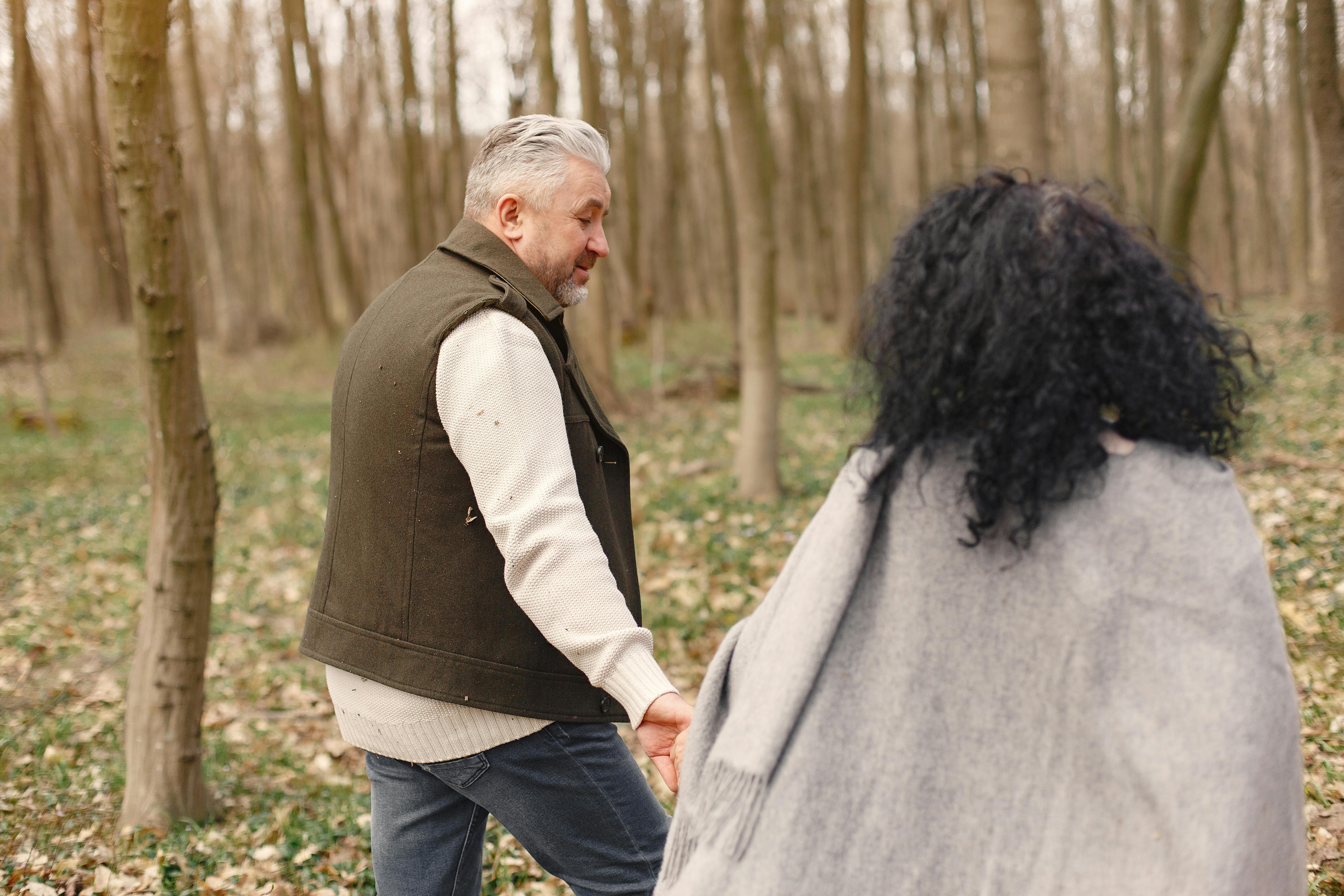 Senior couple walking in the forest.