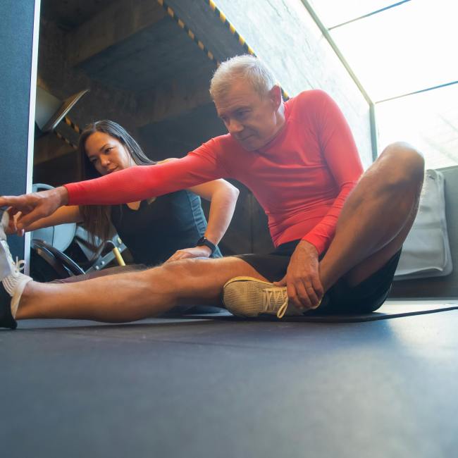 Couple sitting on the floor stretching