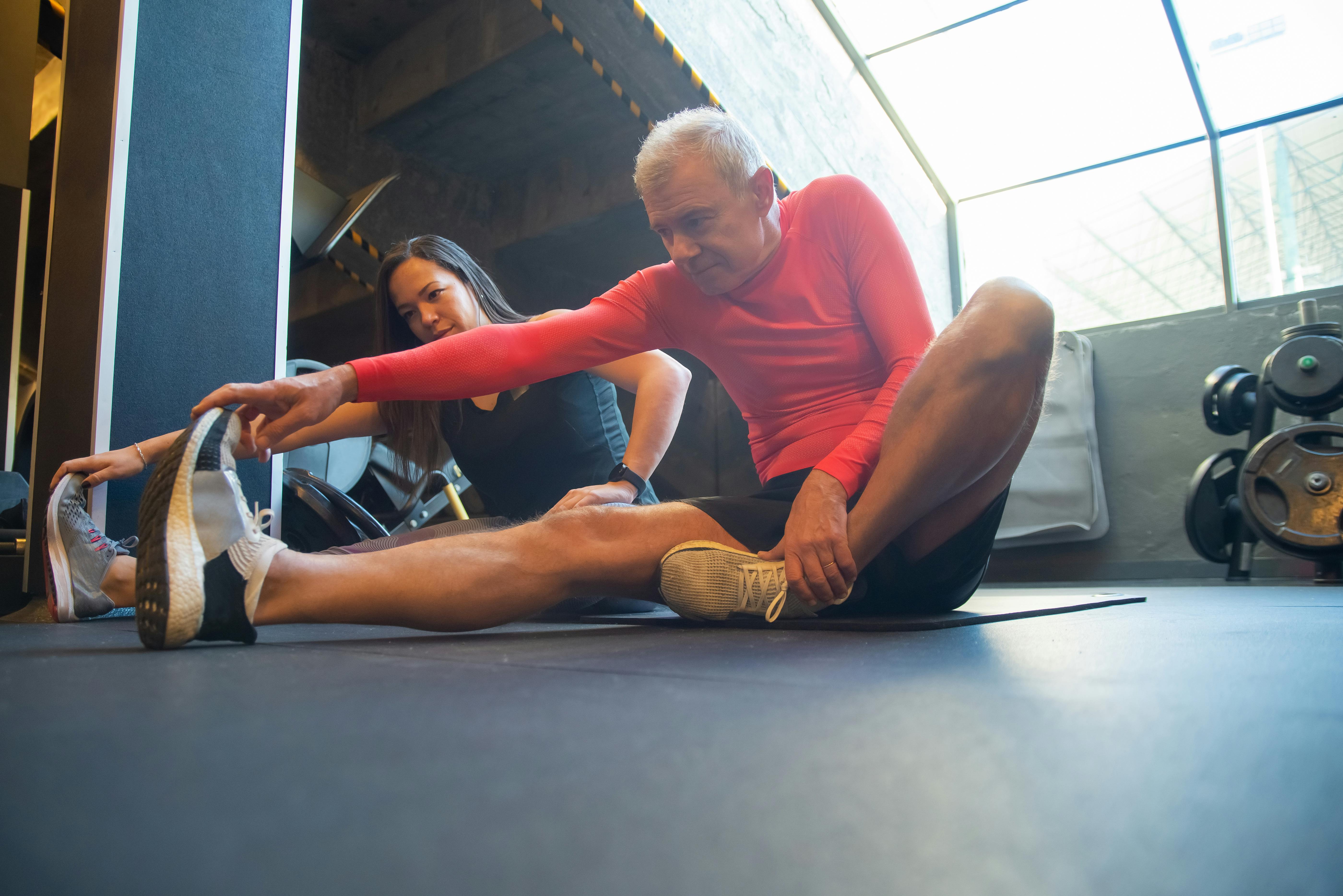 Couple sitting on the floor stretching