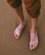 Mens feet on a sandy beach